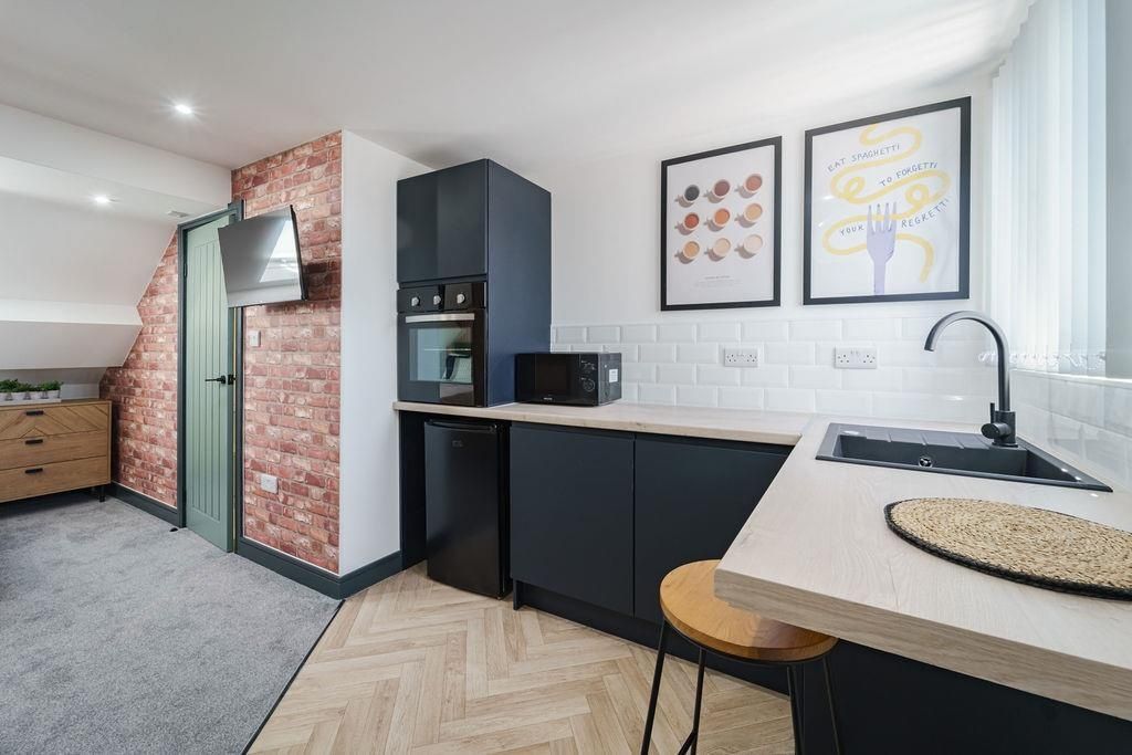 Property photo 1 of 9 Modern Kitchenette With Matte Dark Cabinets, Integ...