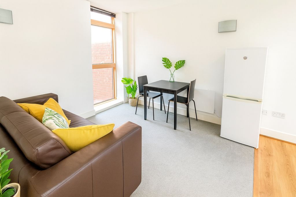 Property photo 3 of 5 Bright And Inviting Living Room Featuring A Comfor...