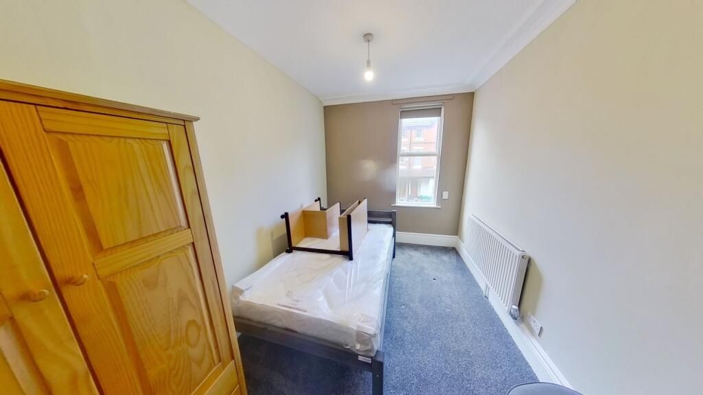 Property photo 2 of 11 A Neat And Cozy Single Bedroom Featuring A Wooden ...