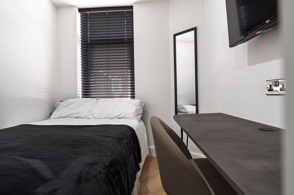 Property photo 3 of 4 A Modern, Well-Lit Bedroom Featuring A Large Windo...