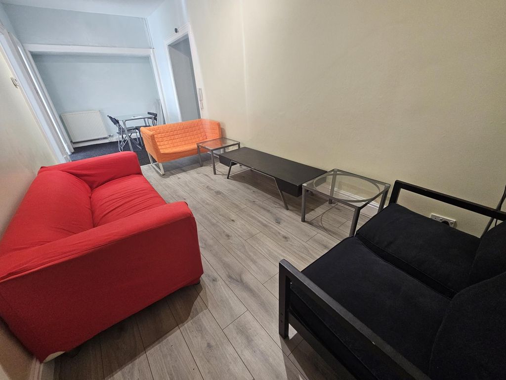 Property photo 3 of 12 A Modern And Cozy Living Room Featuring A Vibrant ...