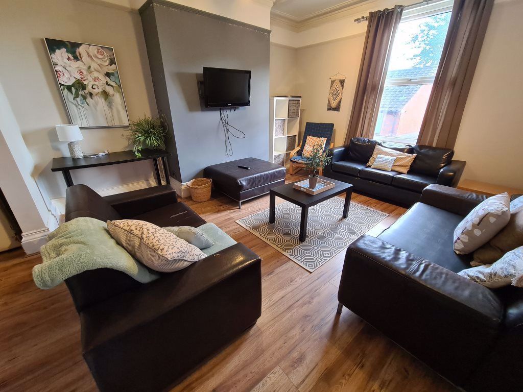 Property photo 1 of 20 A Contemporary Living Room Featuring Dark Leather ...