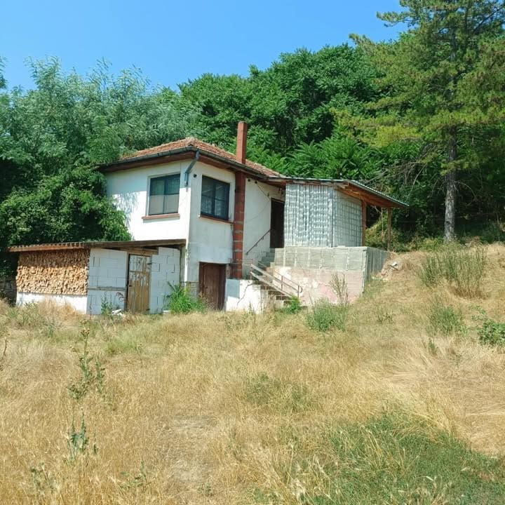 Property photo 2 of 28 Exterior View Of A Two-Storey House With White Walls And A Red Tiled Roof Surrounded By Dry Grass And Trees