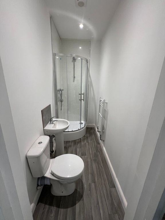 Property photo 3 of 8 A Modern Bathroom Featuring A Curved Glass Shower ...