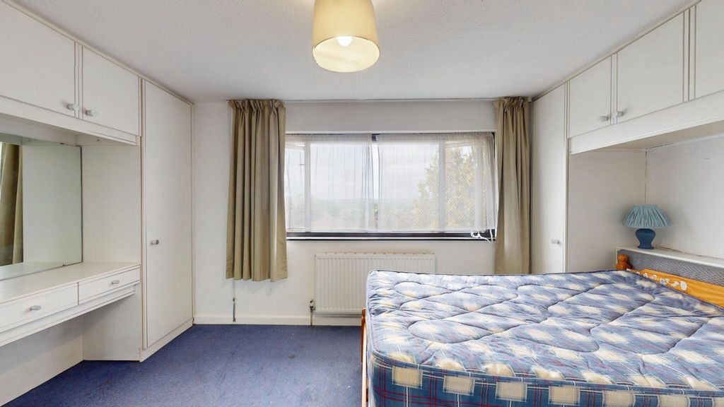 Property photo 3 of 11 A Well-Lit Bedroom Featuring A Large Window That A...