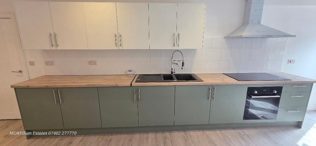 Property photo 1 of 12 Modern Kitchen With Sleek Units And Wood Surfaces...