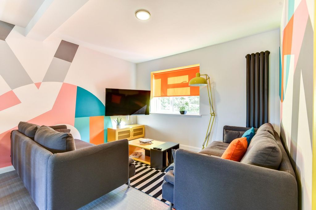 Property photo 3 of 6 Bright And Inviting Living Room Featuring Vibrant ...