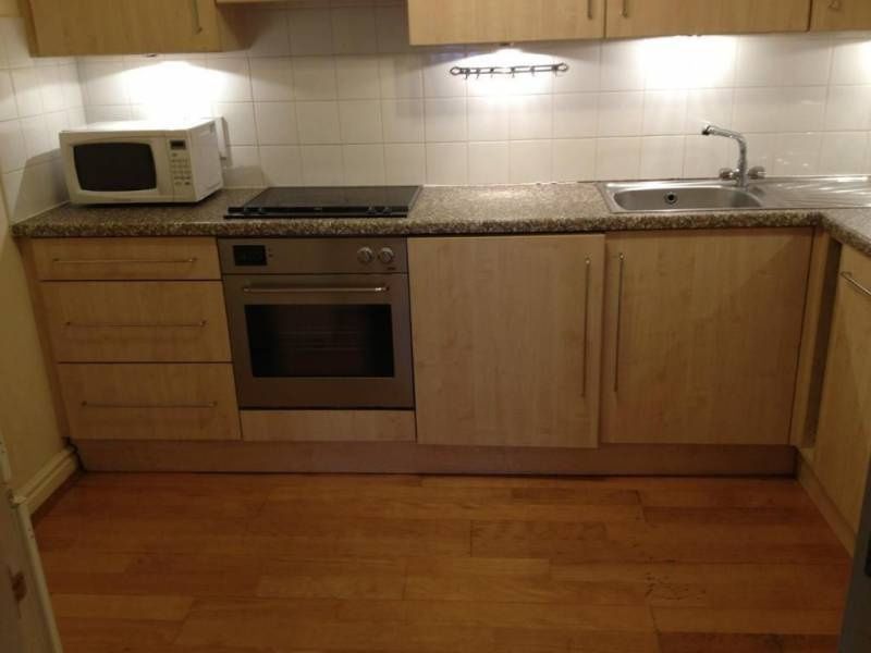 Property photo 3 of 10 A Modern Kitchen Featuring Wood Cabinetry, A Built...