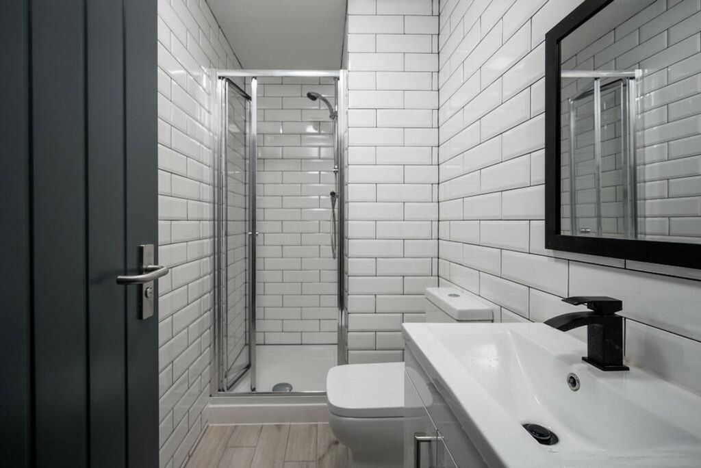 Property photo 2 of 10 A Modern And Clean Bathroom Featuring Stylish Tile...
