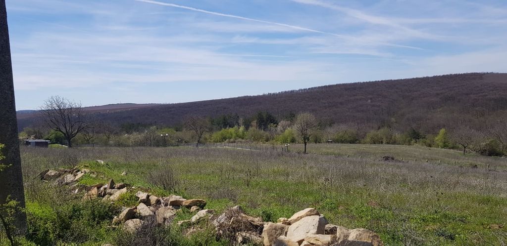 Property photo 3 of 6 Wide View Of An Open Grassy Field With A Low Stone Wall In The Foreground And Wooded Hills In The Background.