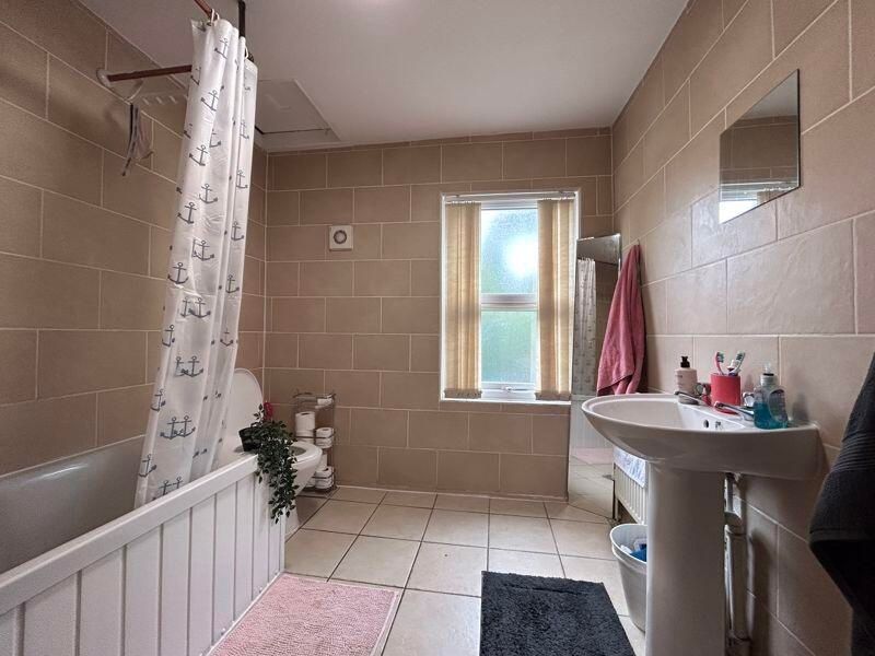 Property photo 3 of 8 Bright And Tidy Bathroom With A Full Bath And Show...