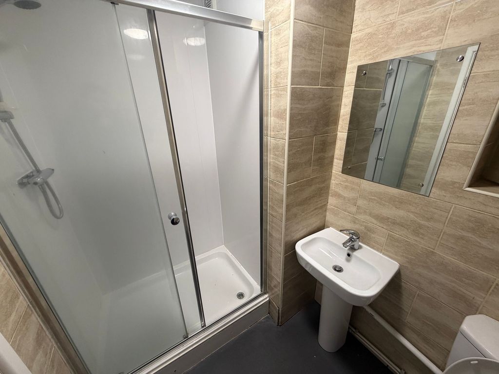Property photo 2 of 58 Modern Tiled Bathroom With A Glass-Enclosed Shower...