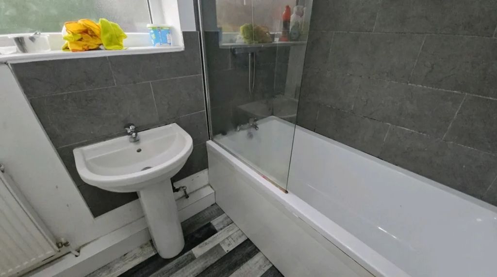 Property photo 1 of 8 A Modern Bathroom Featuring A Stylish Bathtub And ...