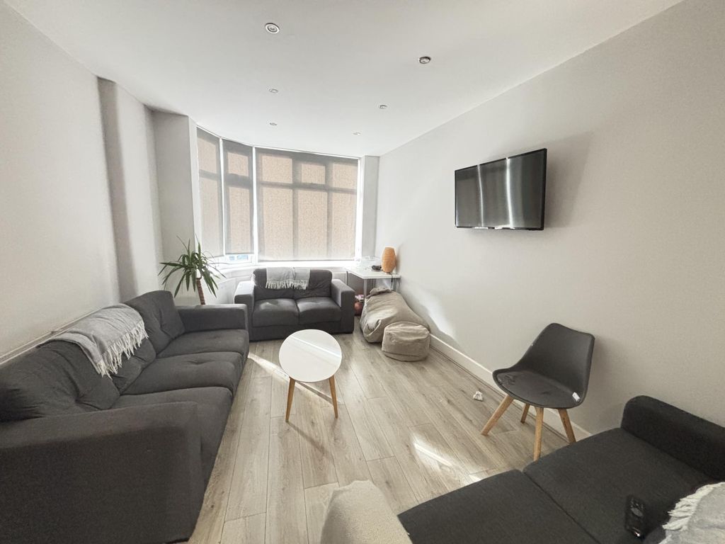 Property photo 3 of 23 Bright And Modern Living Room Featuring Ample Natu...