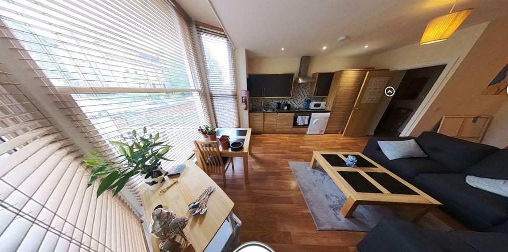 Property photo 3 of 15 A Bright And Modern Living Room Featuring Large Wi...