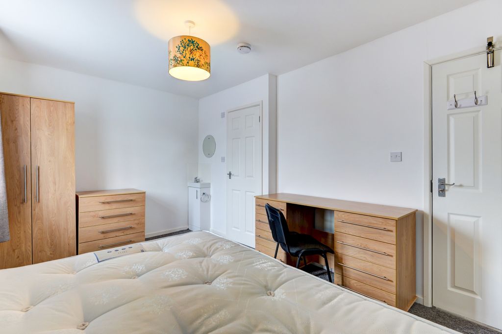 Property photo 2 of 10 A Well-Lit, Tidy Bedroom Featuring A Comfortable-l...