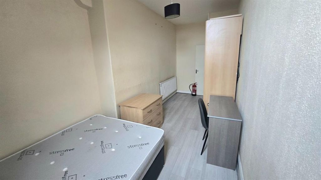 Property photo 2 of 11 A Modest Student Bedroom Featuring A Bed With Some...