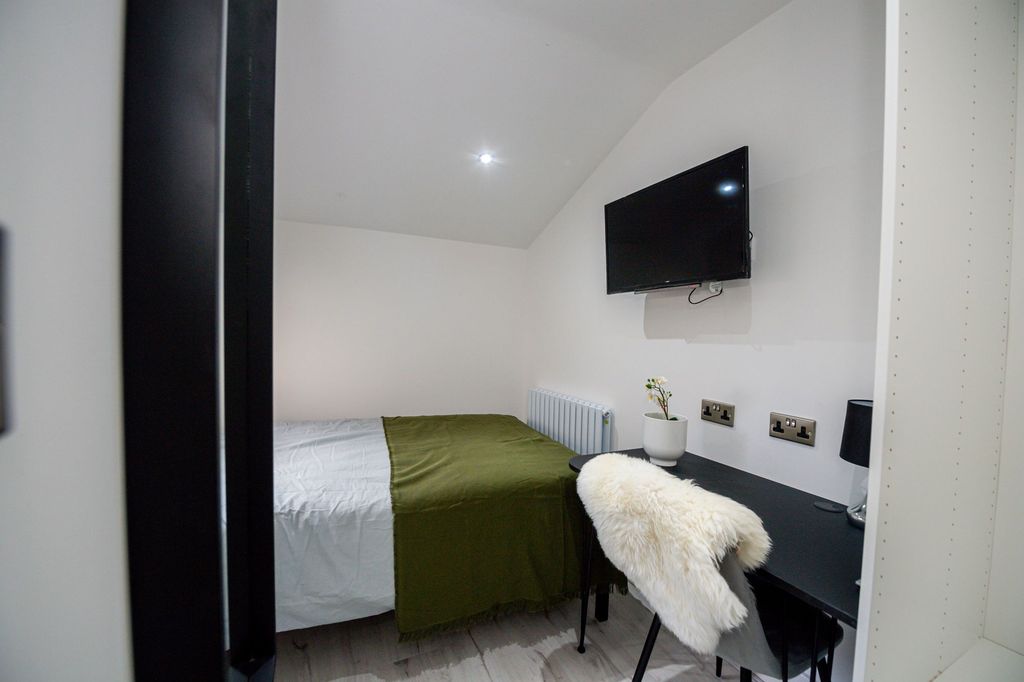 Property photo 3 of 6 A Cozy Single Bedroom With A Neat Bed, A Desk With...