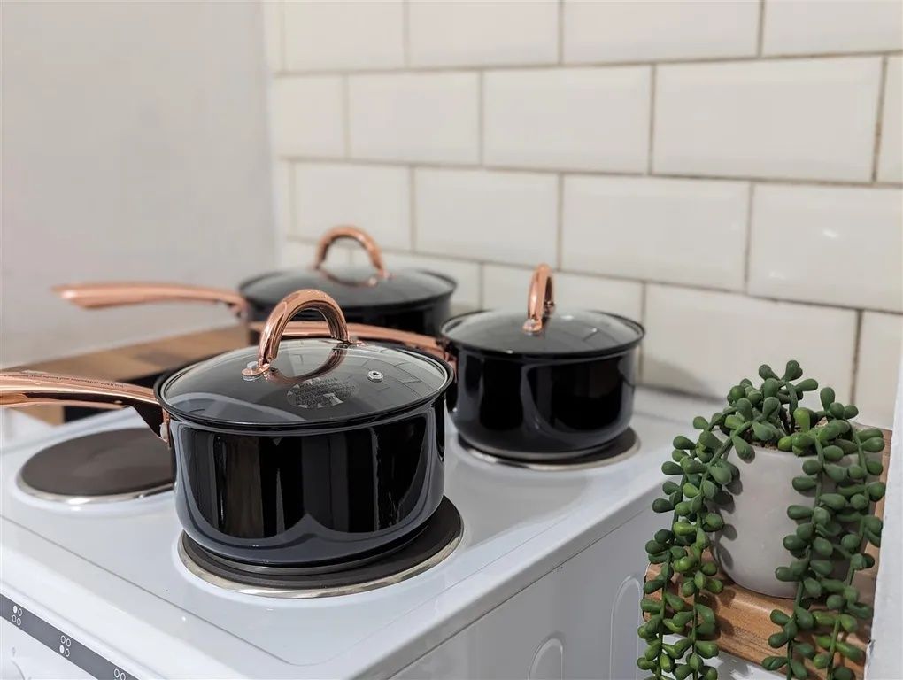 Property photo 3 of 9 A Modern Kitchen Featuring A White Countertop, Bla...