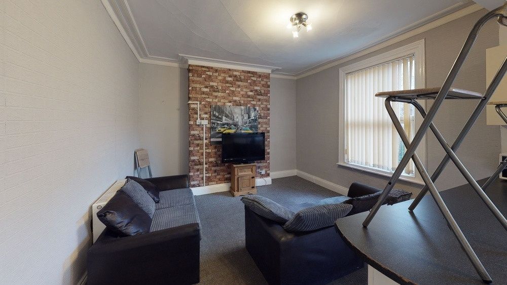 Property photo 1 of 4 A Cozy Living Room Featuring A Stylish Exposed Bri...