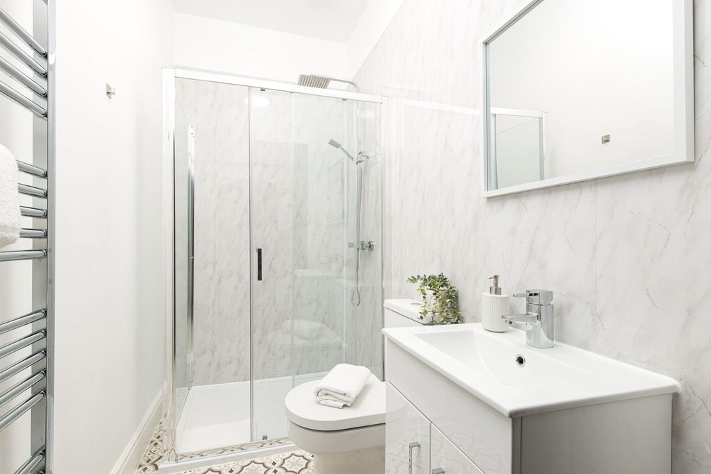 Property photo 3 of 15 Bright, Modern Bathroom Featuring A Glass-Enclosed...