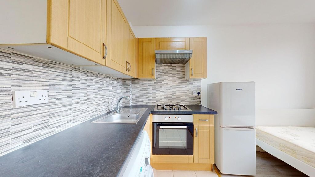 Property photo 3 of 11 A Well-Organized Kitchen Featuring Wooden Cabinets...