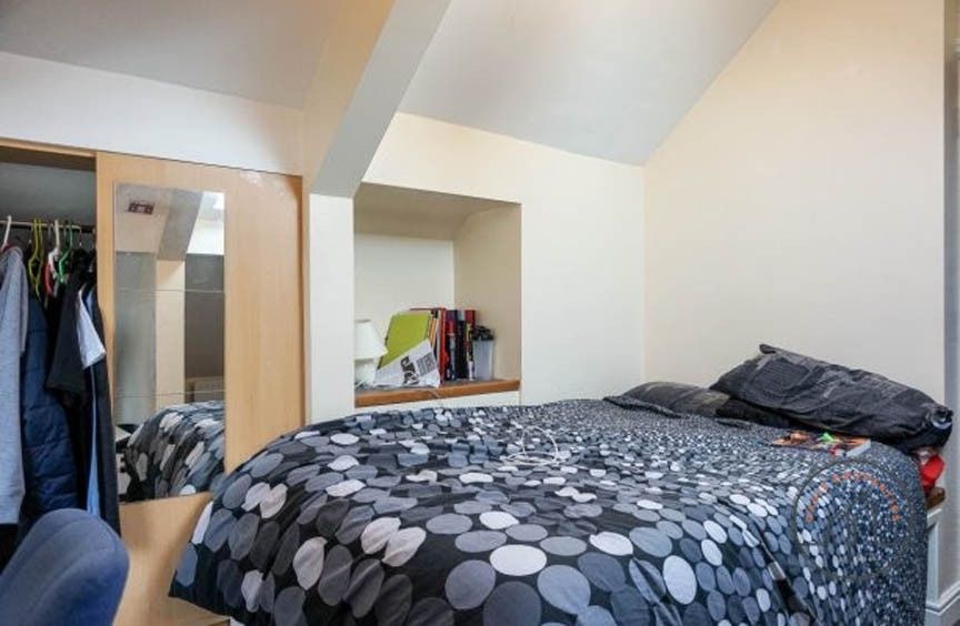 Property photo 3 of 5 A Cozy Bedroom Featuring A Bed With A Patterned Du...