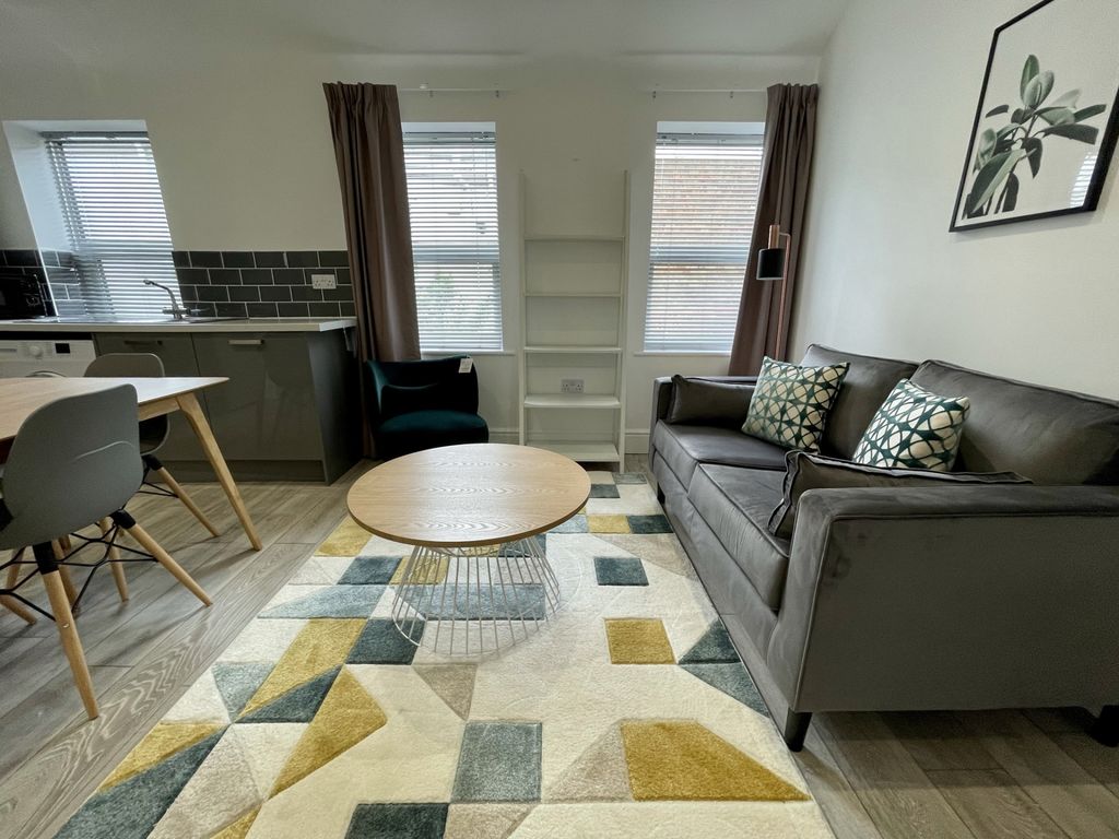 Property photo 1 of 6 A Bright And Inviting Living Room Featuring A Comf...