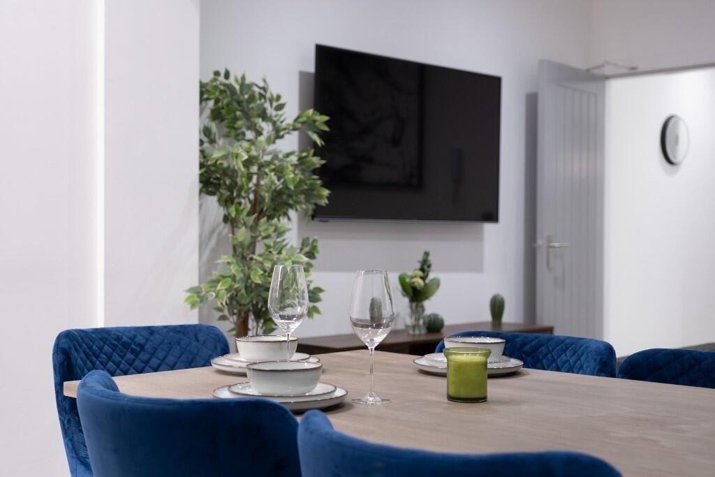 Property photo 3 of 11 A Modern, Well-Lit Living Room Featuring Stylish B...