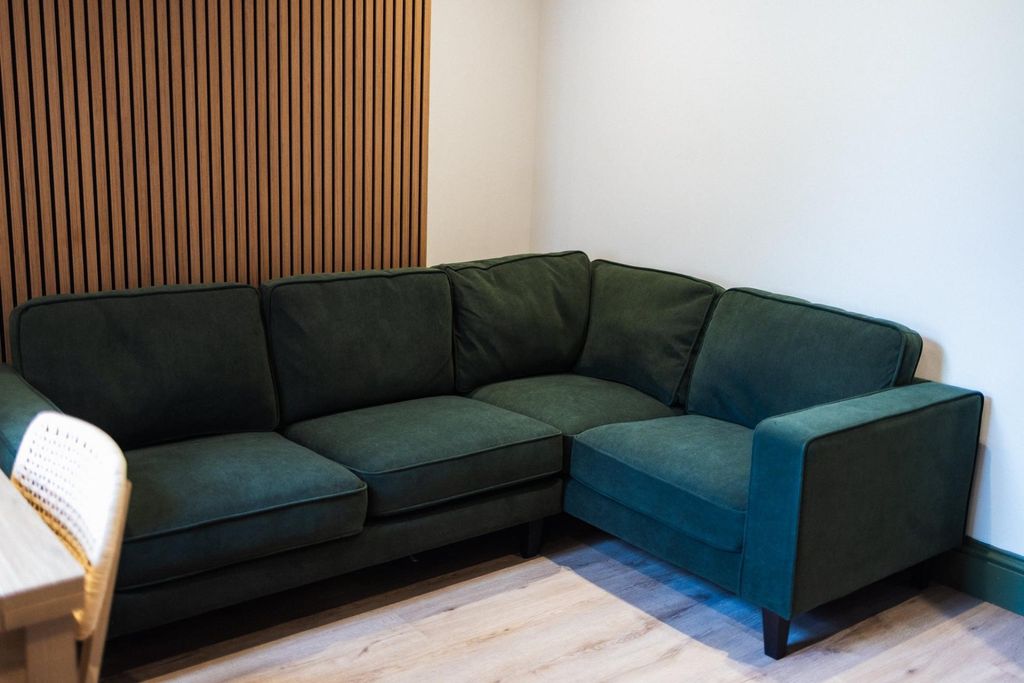 Property photo 3 of 12 A Cozy Living Room Corner Featuring A Plush Dark G...