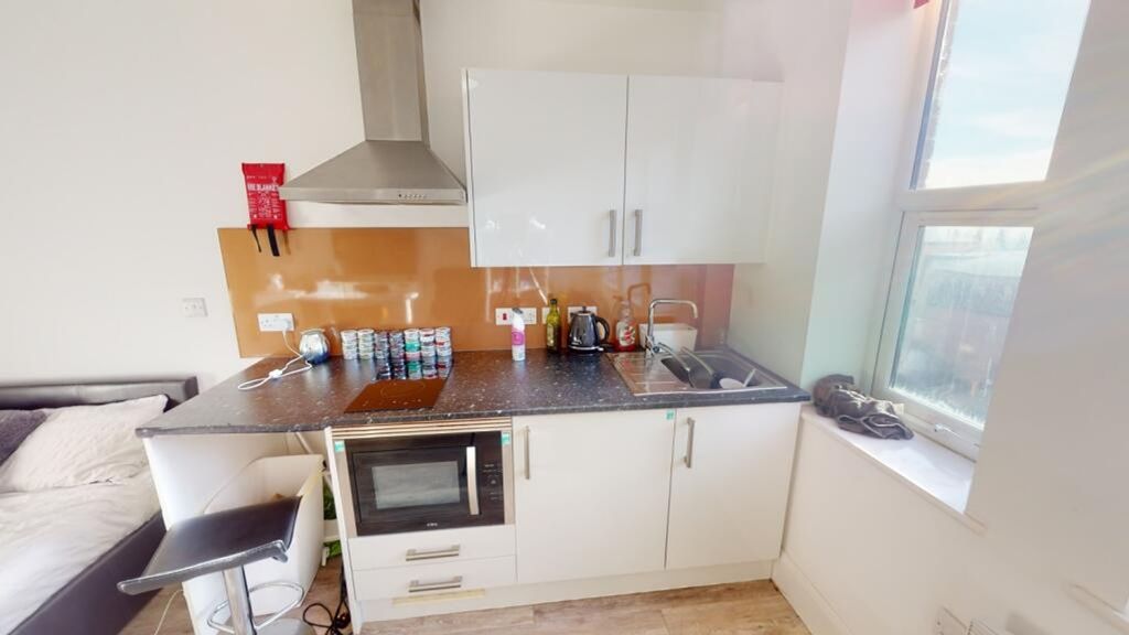Property photo 3 of 4 This Modern Kitchen Features A Sleek Design With A...