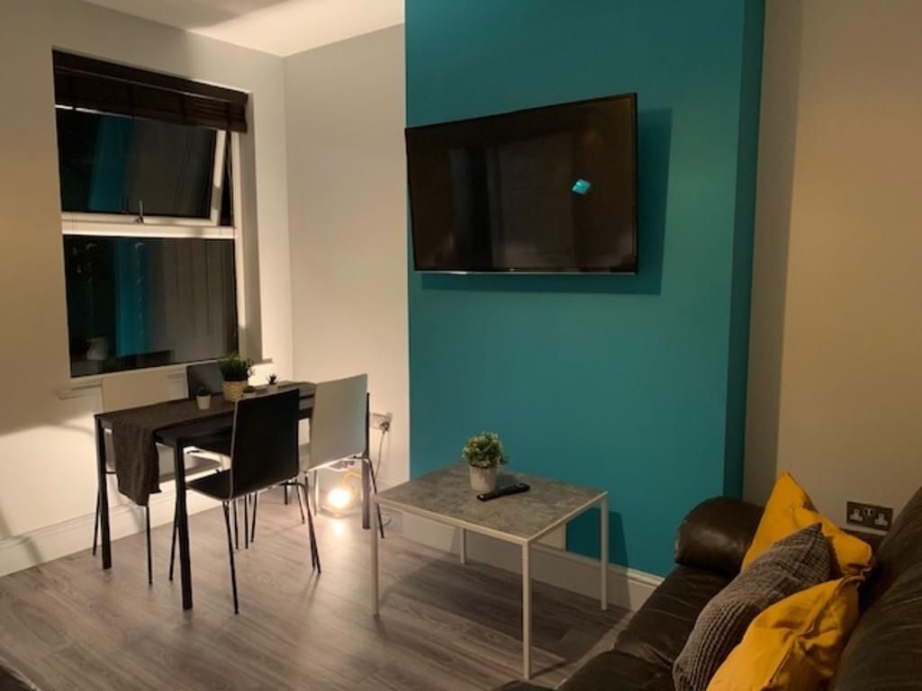 Property photo 3 of 15 Contemporary Living Room With A Sleek TV Mounted O...