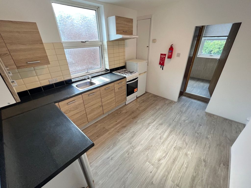 Property photo 2 of 12 Bright And Clean Kitchen Featuring Modern Wood-Eff...