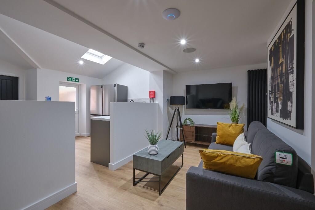 Property photo 3 of 13 A Modern, Well-Lit Living Room Featuring Comfortab...