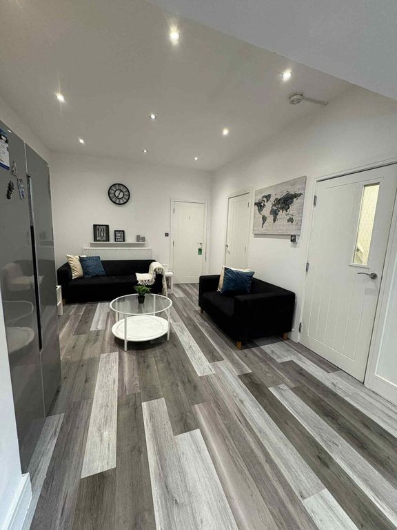 Property photo 3 of 13 Modern And Inviting Living Room Featuring Sleek Bl...