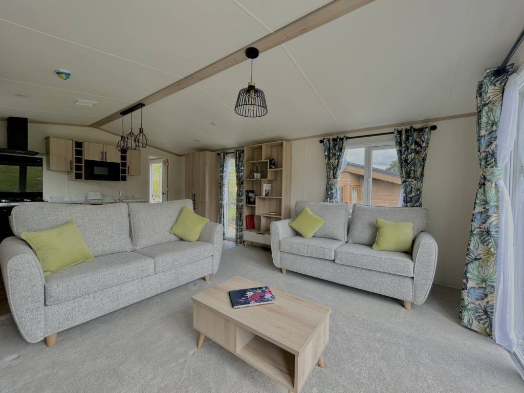 Property photo 2 of 12 Regal Charmouth Open Plan Lounge With Freestanding Sofas And Botanical Curtains