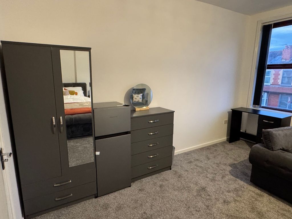 Property photo 2 of 11 A Spacious Master Bedroom Featuring Modern Dark Gr...