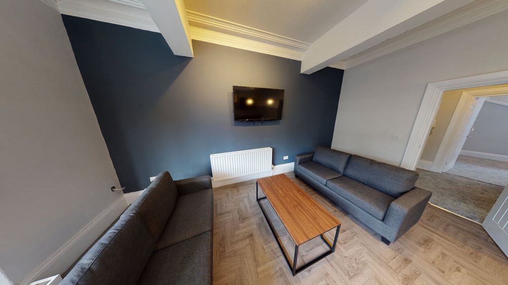 Property photo 2 of 11 A Spacious And Modern Living Room Featuring Contem...