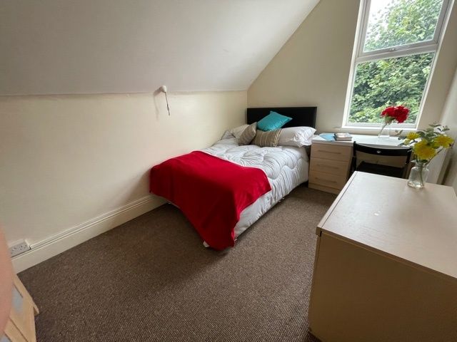 Property photo 2 of 18 A Cozy Bedroom Featuring A Single Bed Draped With ...