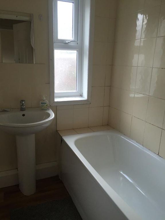 Property photo 2 of 7 Bright Bathroom Suite Featuring A Clean White Bath...