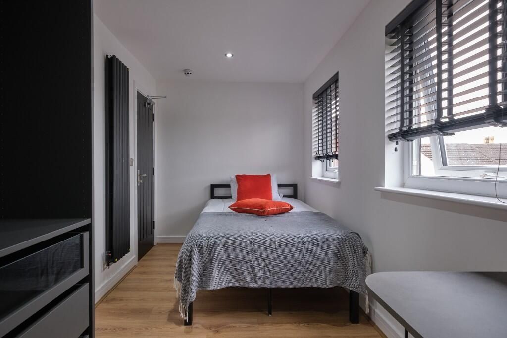 Property photo 1 of 13 A Bright And Tidy Bedroom Featuring Two Large Wind...