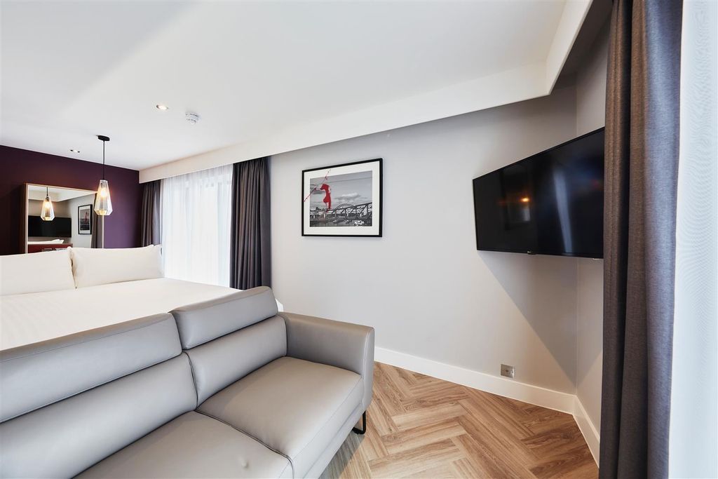 Property photo 2 of 5 Elegant Suite With Stylish Sofa And Wall-Mounted T...