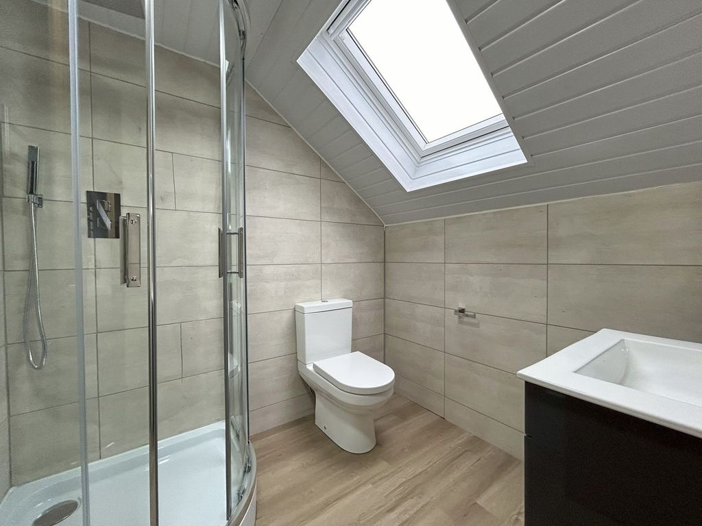 Property photo 3 of 9 A Modern Bathroom Featuring A Corner Shower With c...
