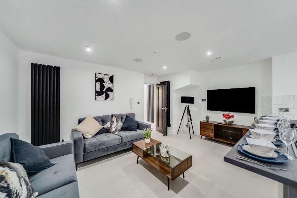 Property photo 3 of 9 A Bright And Modern Living Room Featuring Contempo...