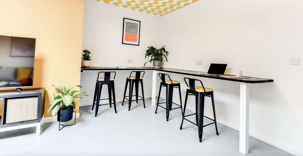 Property photo 2 of 6 A Stylish Communal Workspace Featuring A Sleek Bar...