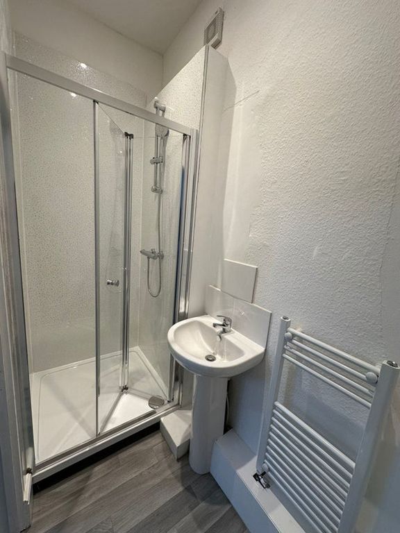 Property photo 1 of 6 A Clean And Modern Bathroom Featuring A Corner Sho...