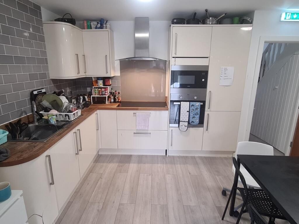 Property photo 3 of 15 A Modern Kitchen Featuring Ample Cabinetry And Woo...