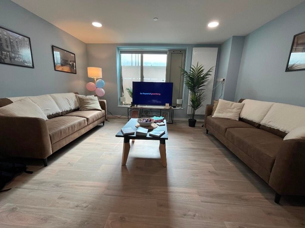Property photo 2 of 15 A Modern Living Room Featuring Two Large Sofas, A ...