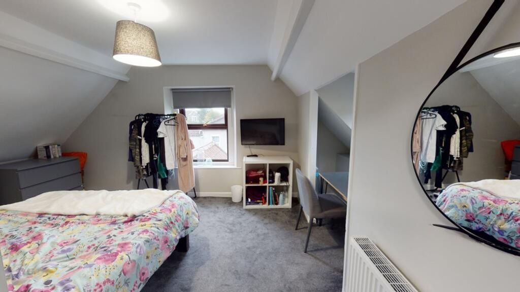Property photo 3 of 8 A Cozy Double Bedroom Featuring A Vibrant Floral B...