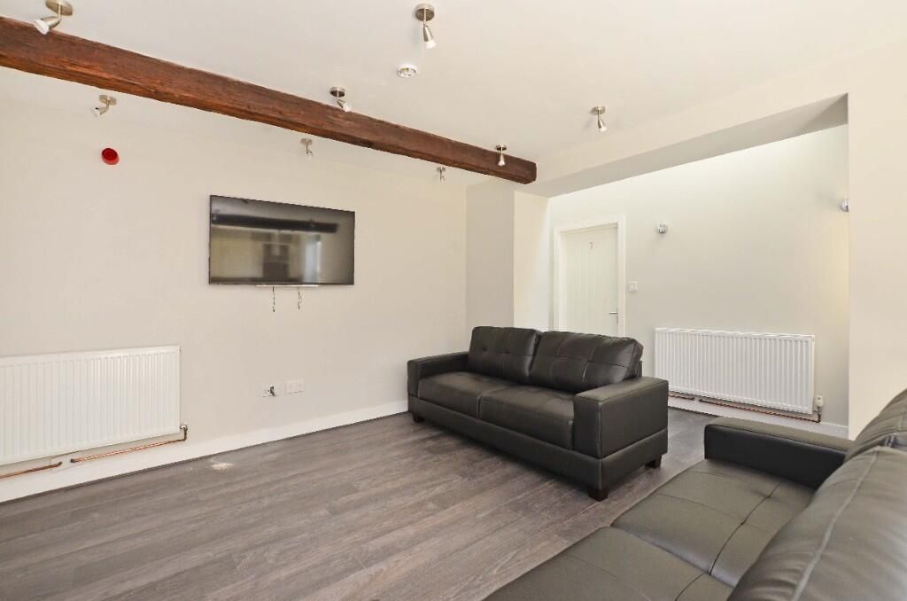 Property photo 3 of 15 A Modern Living Room Featuring Two Black Leather S...